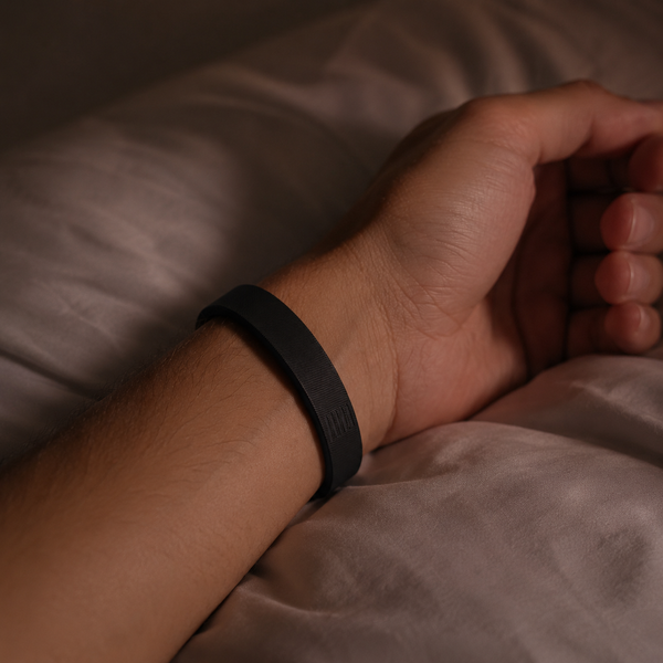 Close-up of the Deep Pulse Band on a wrist resting on a pillow, slim and unobtrusive